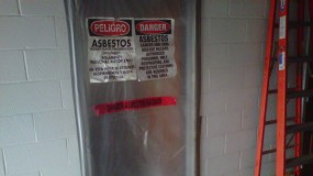 Asbestos abatement warning posted on door